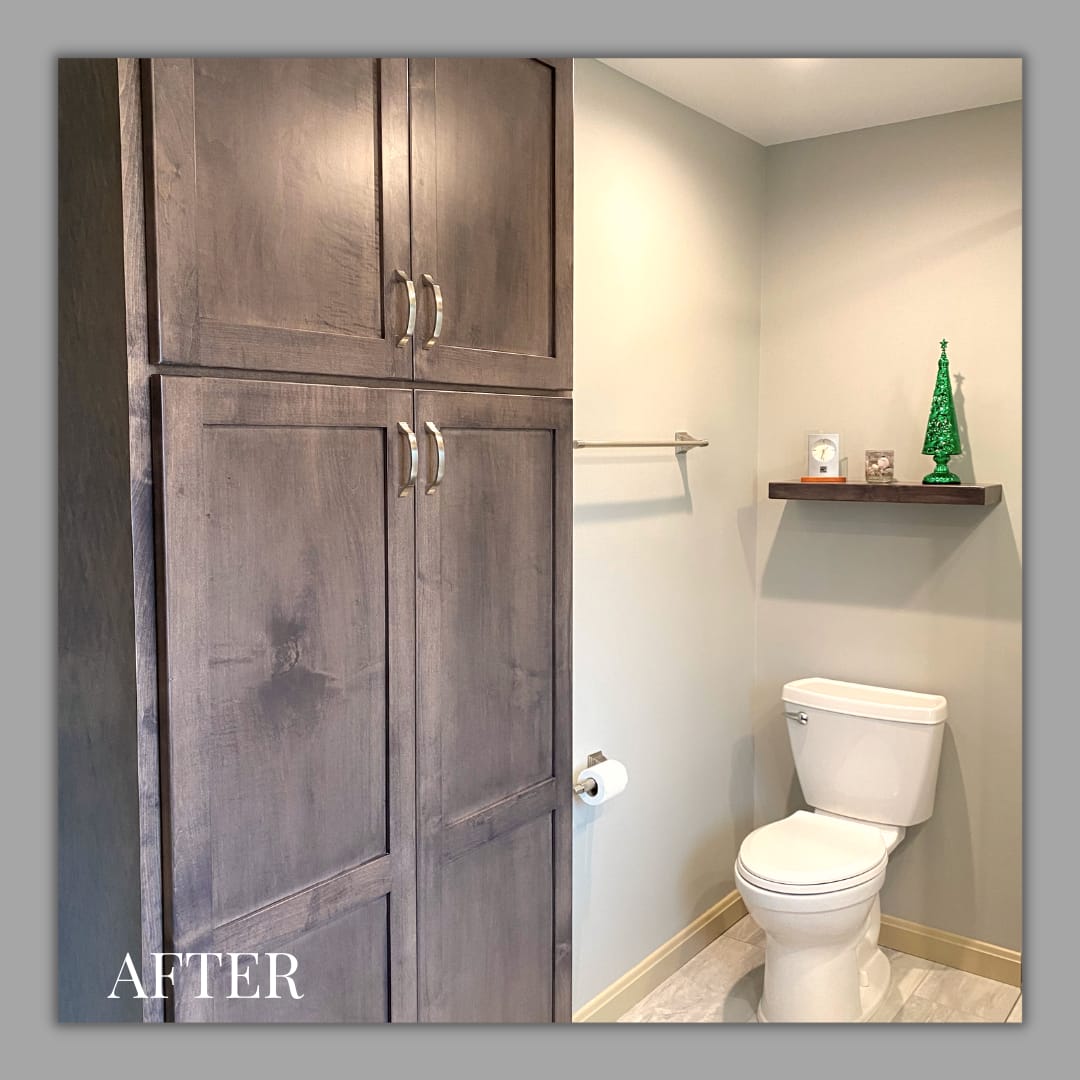 Bathroom with tall grey-stained linen cabinet, floating wood shelf, and tile flooring