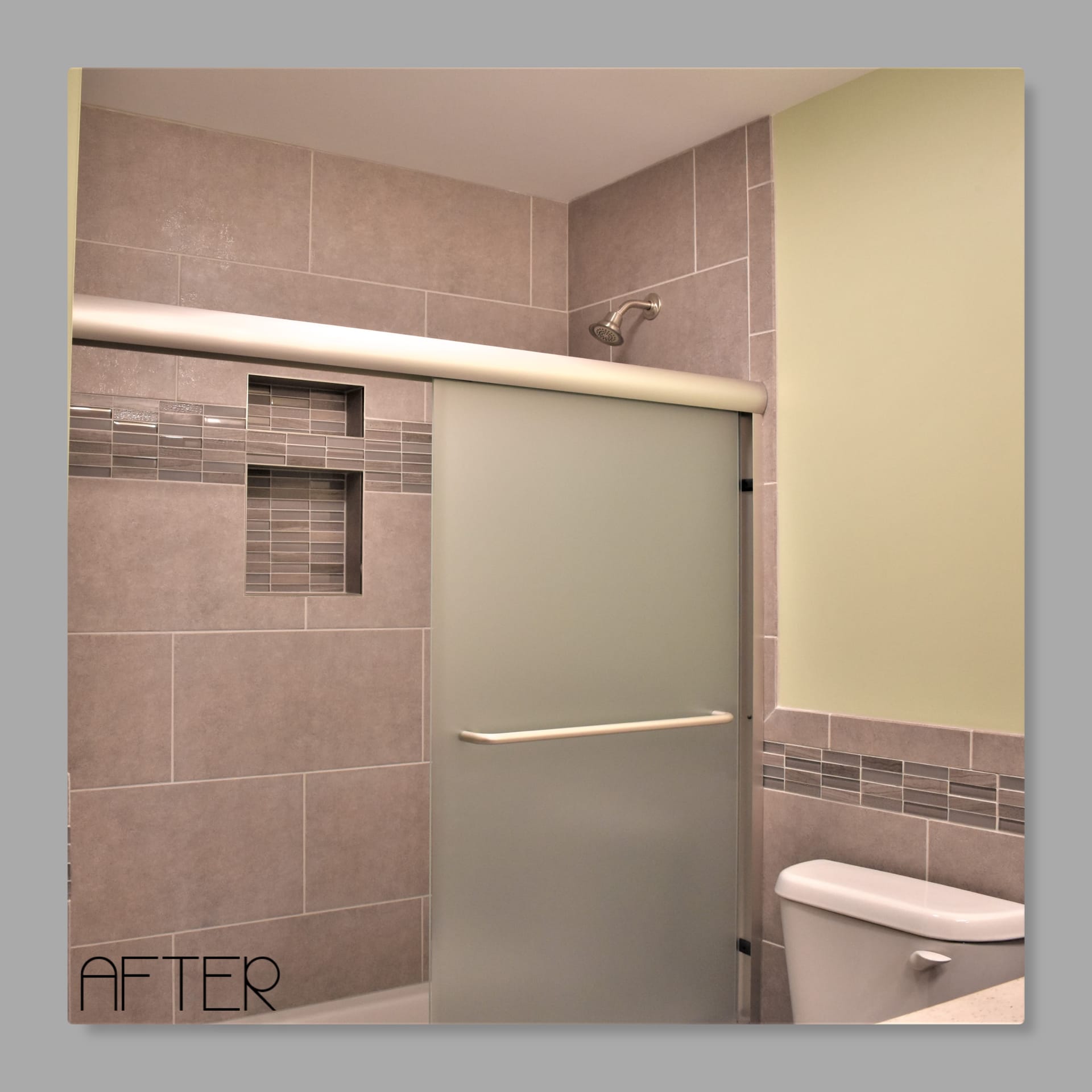 Tile shower with grey tile walls, linear glass mosaic accent, double niche, frosted sliding glass door, Erie PA