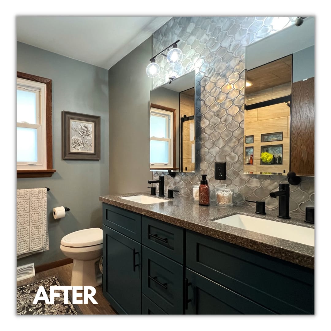 Bathroom double vanity with navy shaker cabinets, speckled granite counter, silver mosaic accent wall, matte-black faucets, Erie County