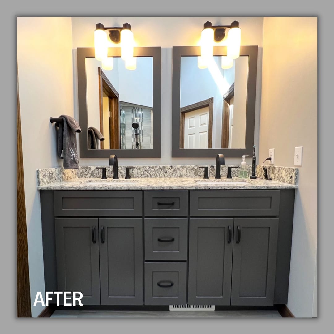 Bathroom double vanity with dark grey shaker cabinets, speckled granite counter, framed mirrors, and matte-black faucets, Erie County