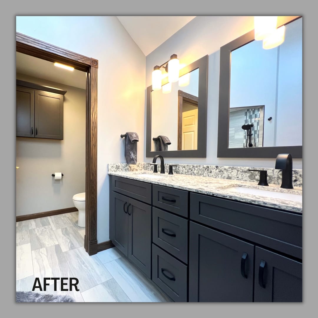 Bathroom double vanity with charcoal shaker cabinets, speckled granite counter, matte-black faucets, and wood-look tile flooring, Erie County