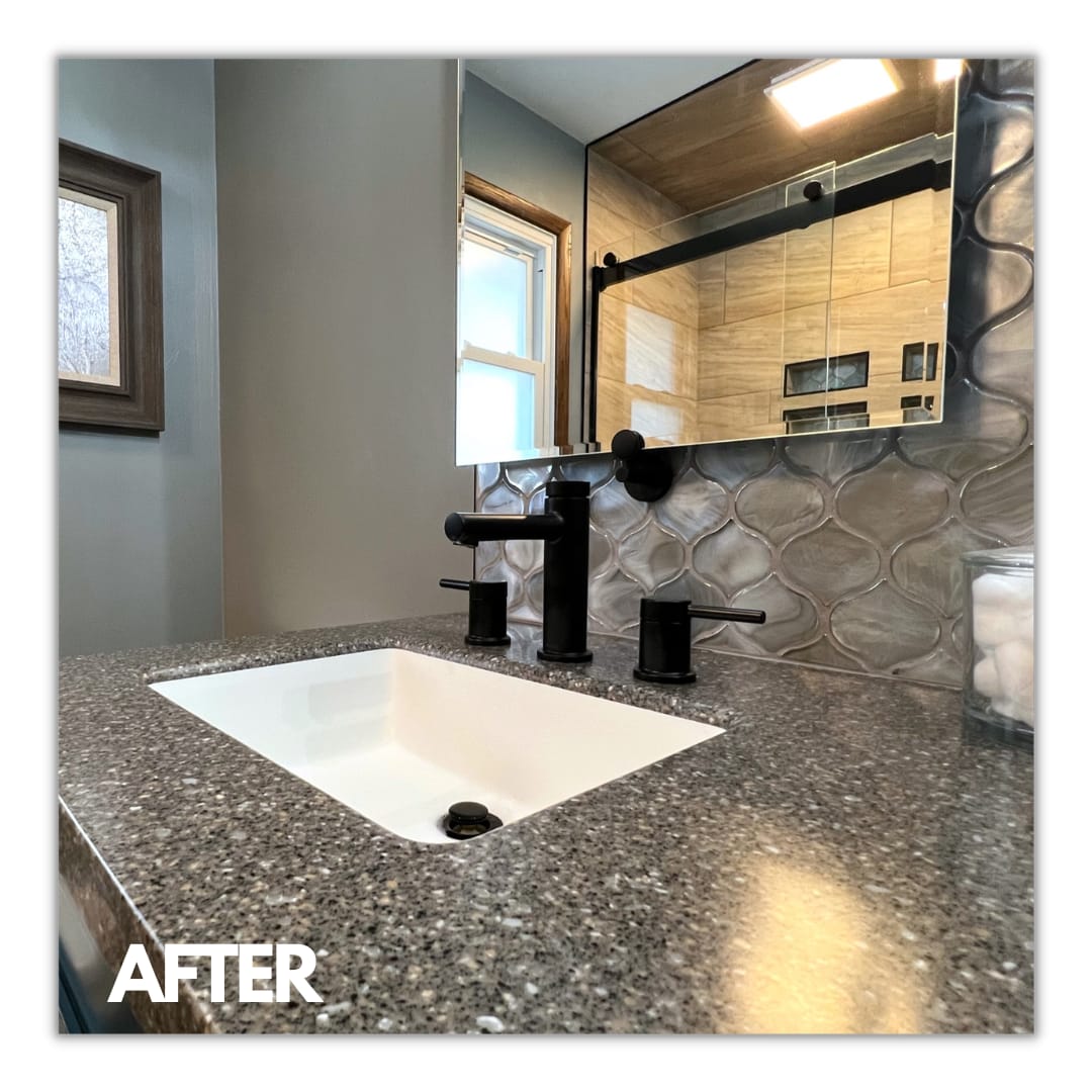 Vanity with speckled counter, undermount sink, matte-black faucet, and silver arabesque mosaic backsplash, Edinboro
