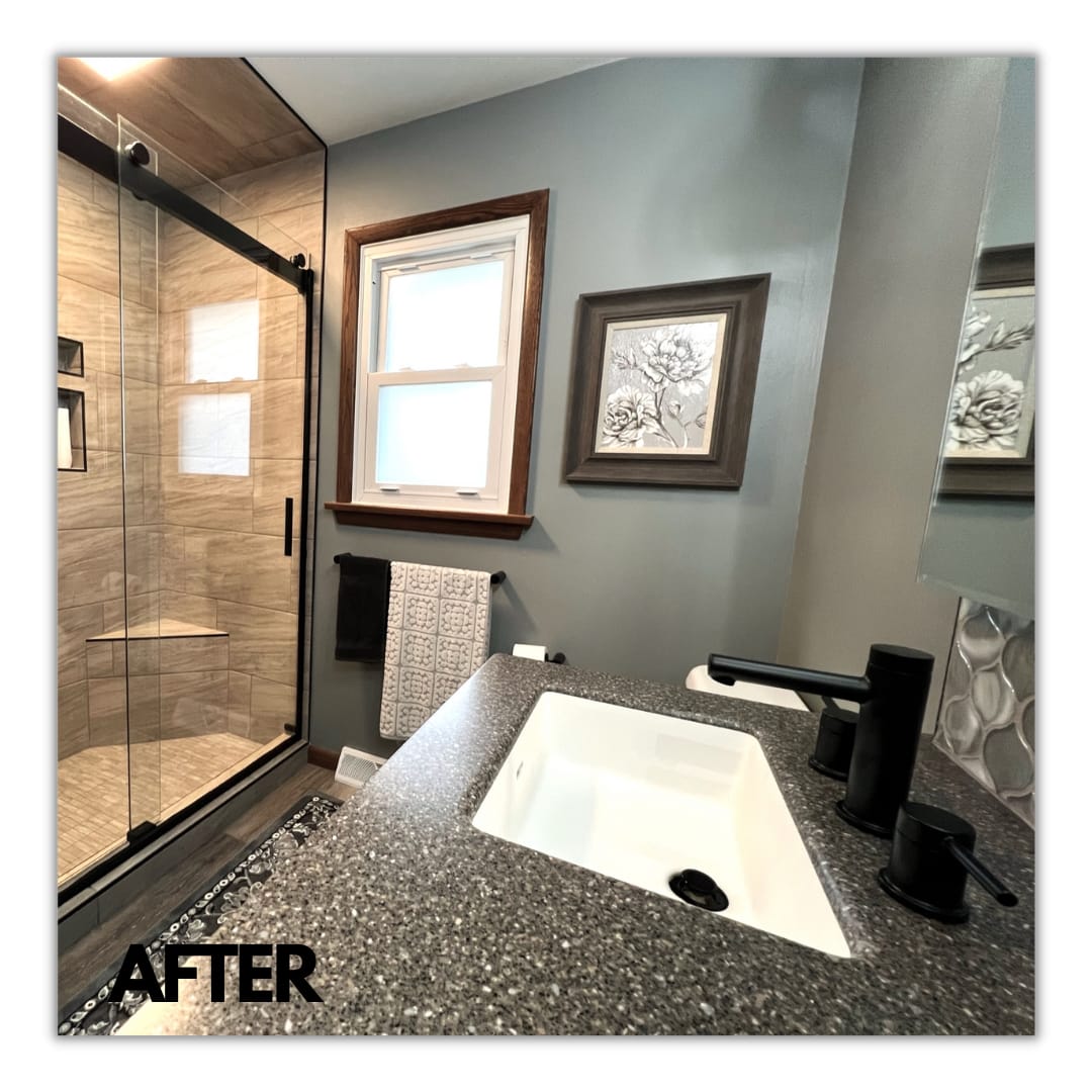 Bathroom with glass tile shower, speckled granite vanity, matte-black faucet, and arabesque mosaic backsplash