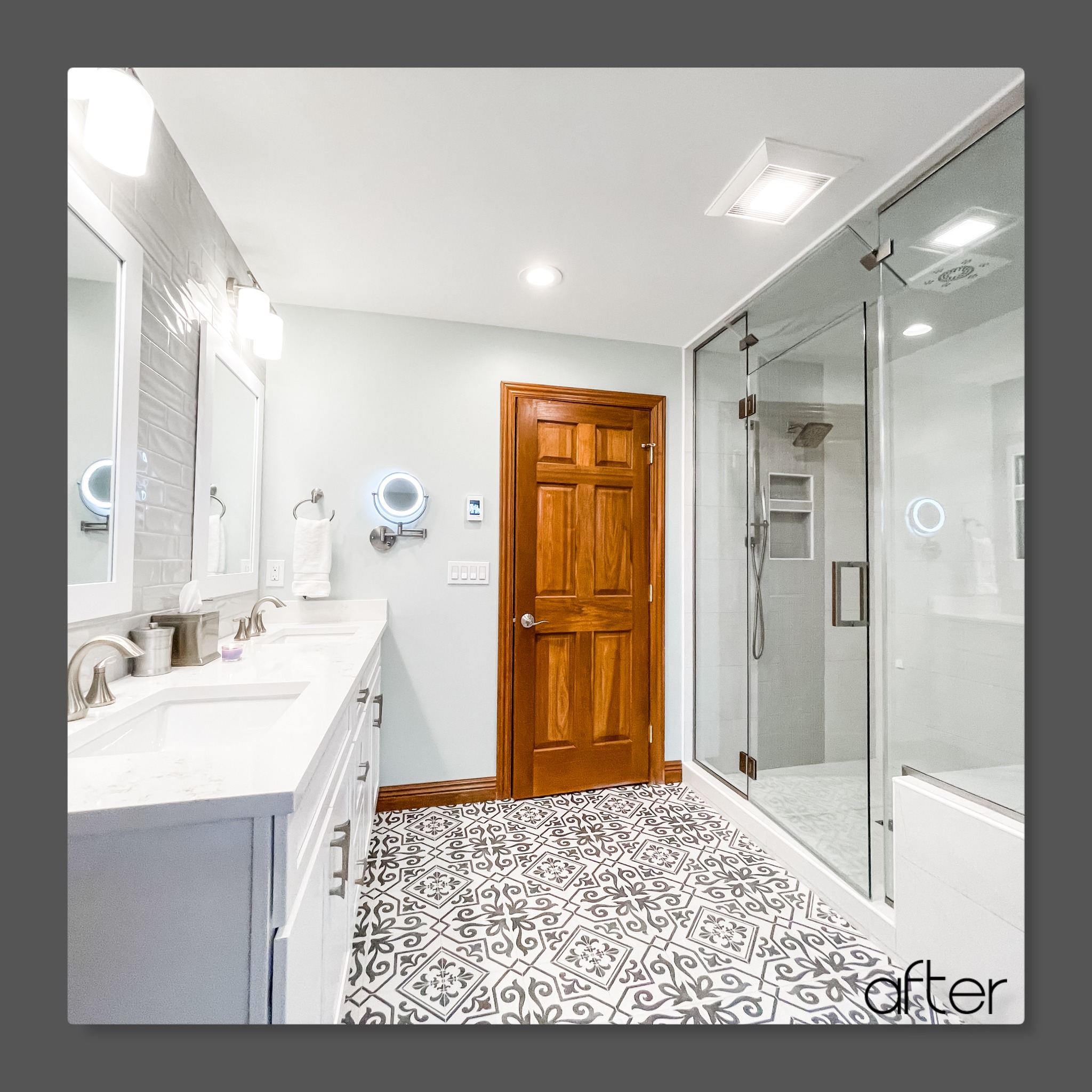 Bathroom with white double vanity, light quartz counters, patterned cement tile floor, glass shower, and grey subway tile