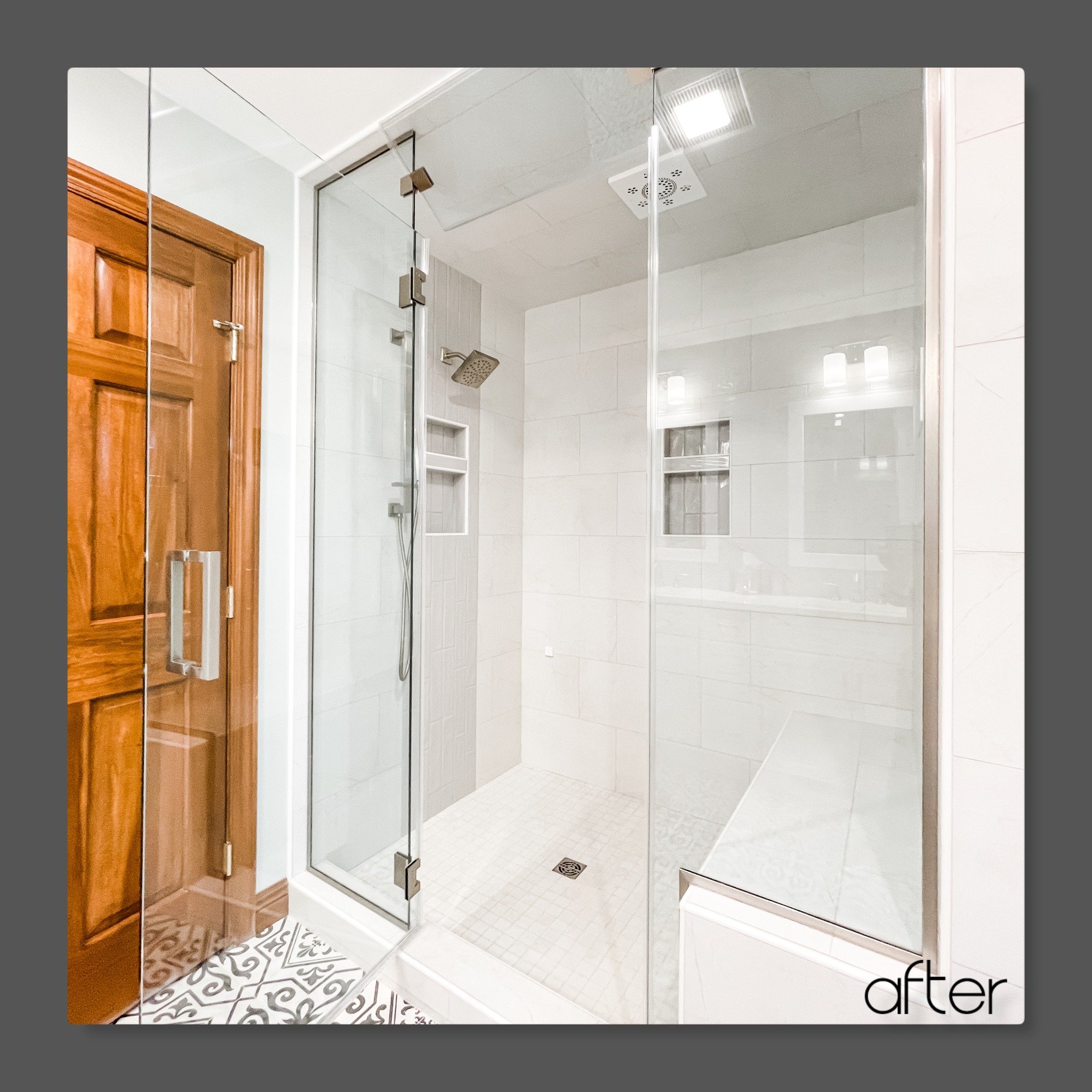 Enclosed glass shower with white marble-look tile, ceiling rain head, recessed niches, bench seat, and mosaic tile floor