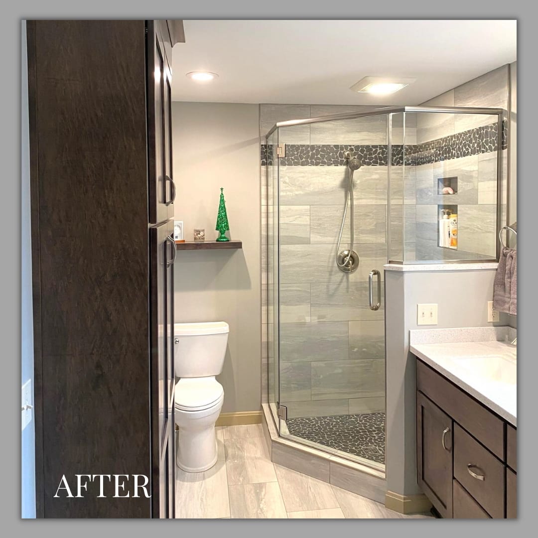 Bathroom with corner glass tile shower, black pebble mosaic accent, grey-stained shaker vanity, wood-look plank flooring, Erie PA