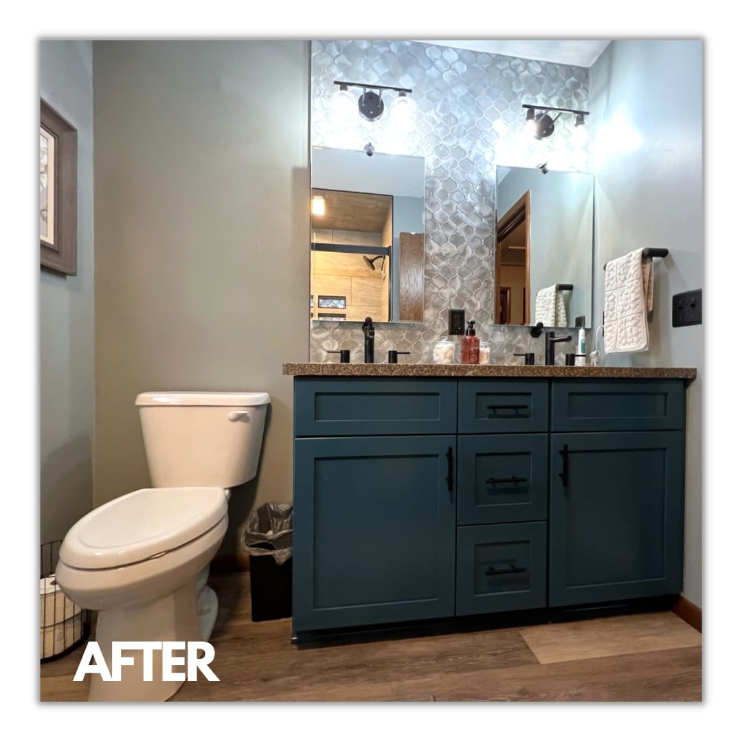 Bathroom double vanity with teal shaker cabinets, speckled granite counter, silver arabesque mosaic accent wall, and matte-black faucets