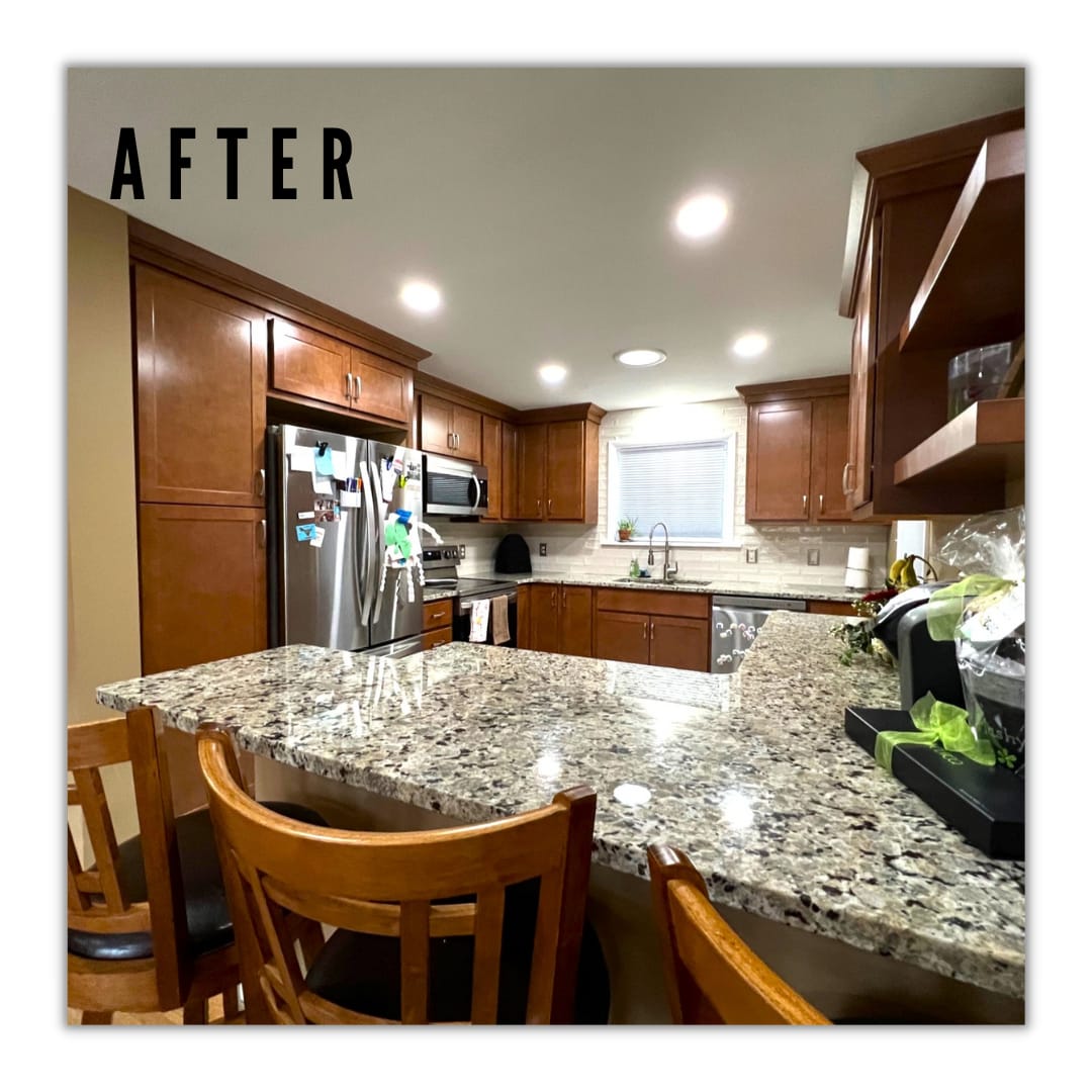 Cherry-toned wood kitchen with speckled granite peninsula, tile backsplash, stainless appliances, and wood barstools