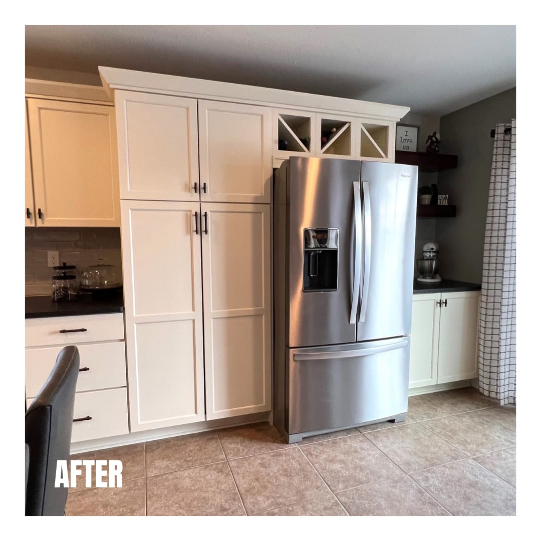 White shaker kitchen with floor-to-ceiling pantry cabinets, glass wine cubby, stainless french-door refrigerator, and tile flooring