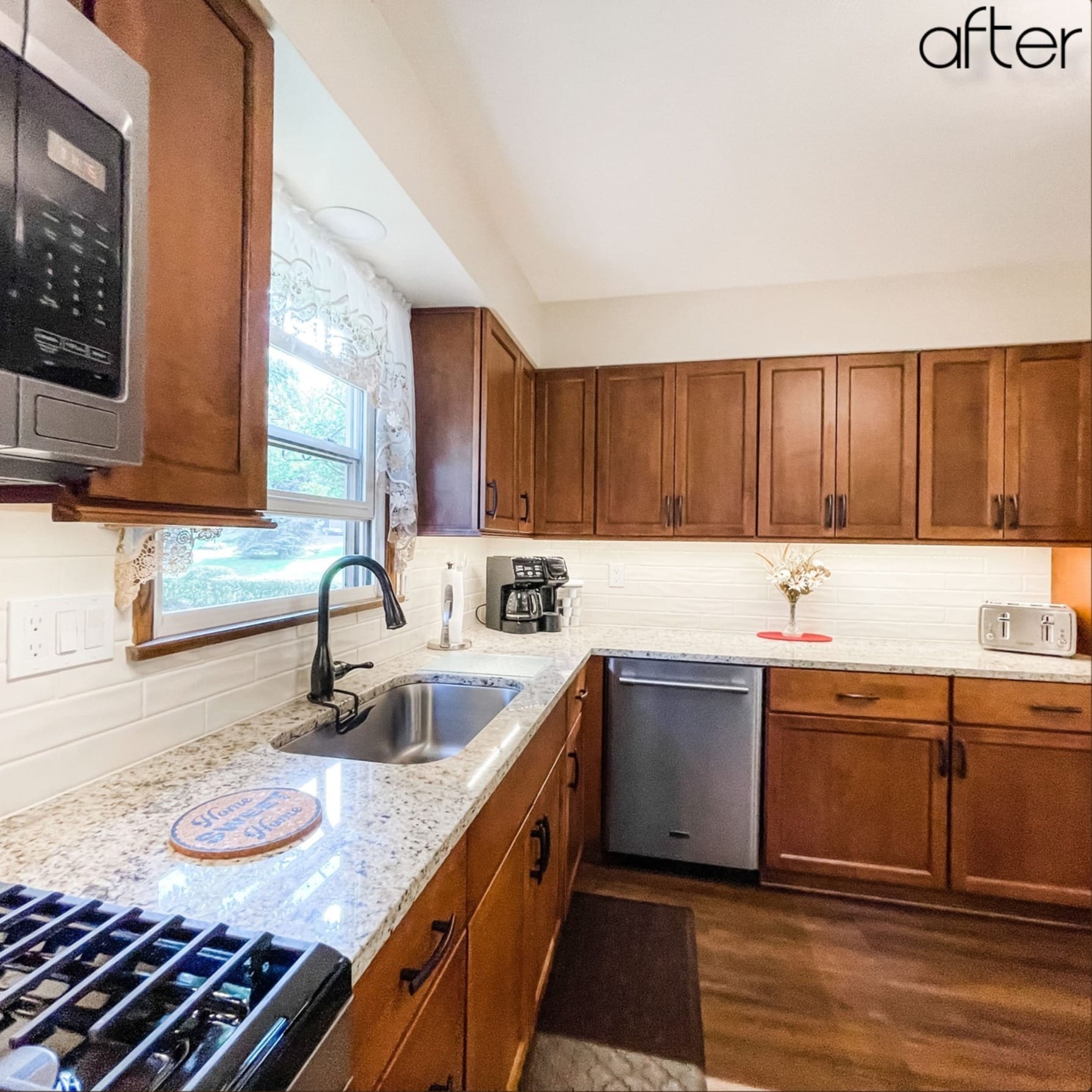Oak shaker kitchen with white subway tile, speckled granite counters, stainless dishwasher, and wood-look plank flooring, Edinboro