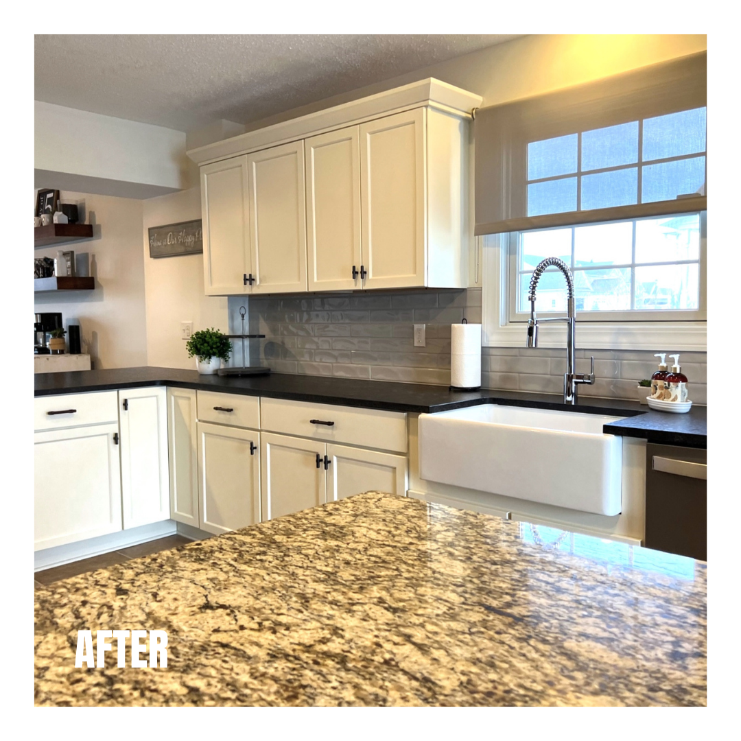 Cream shaker kitchen with black counters, granite island, grey subway tile backsplash, apron farmhouse sink, and floating shelves