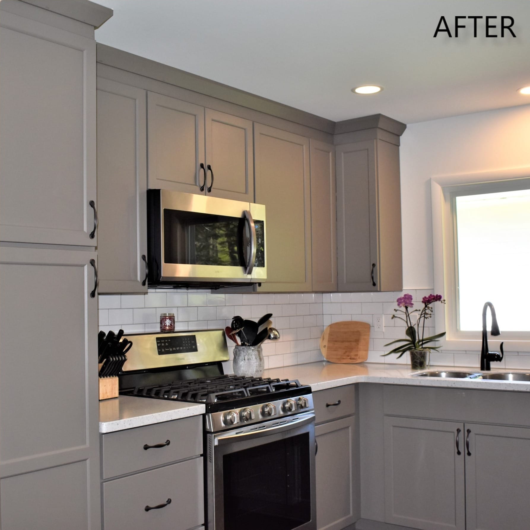 Greige shaker kitchen with white subway tile, white quartz counters, tall pantry cabinet, and matte-black faucet, Erie County